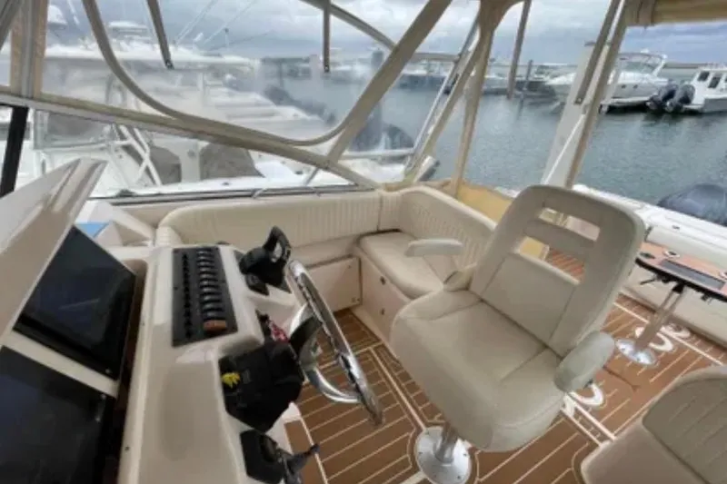 Slide: The Image of Interior of a 2007 Grady-White Express 330 boat with helm and seating area. - 16