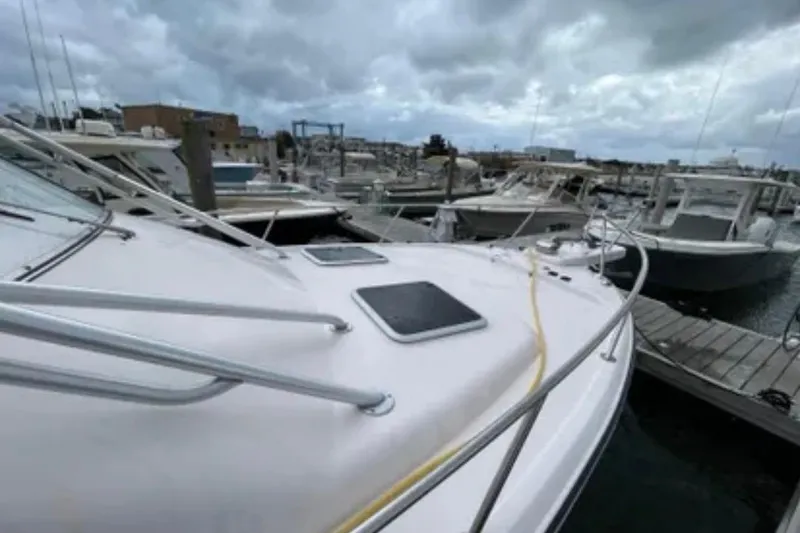 Slide: The Image of 2007 Grady-White Express 330 boat docked at a marina under cloudy skies. - 17