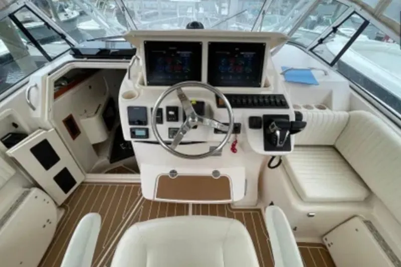 Slide: The Image of 2007 Grady-White Express 330 helm with dual screens and plush seating. - 18
