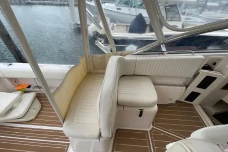 Slide: The Image of 2007 Grady-White Express 330 boat interior with white seating and wooden flooring. - 20