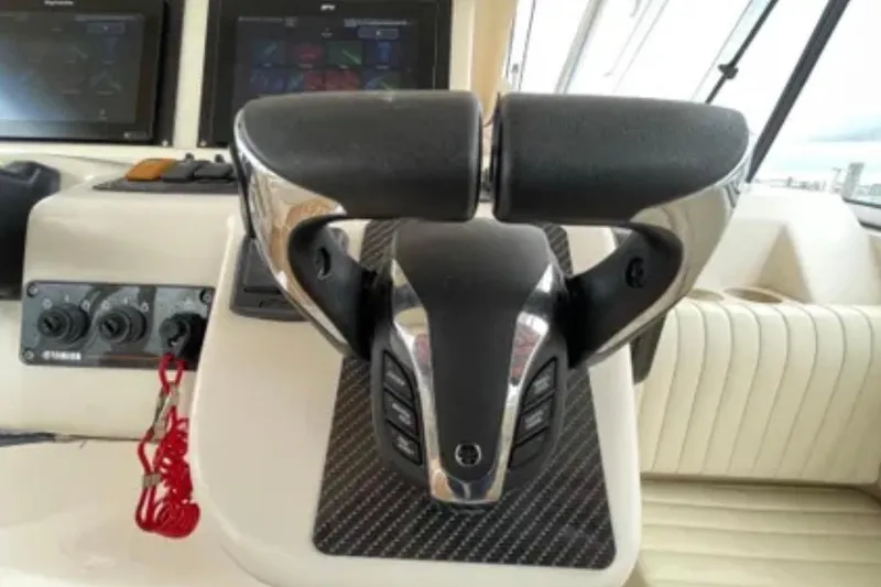 Slide: The Image of Throttle controls on a 2007 Grady-White Express 330 boat dashboard with navigation screens. - 21