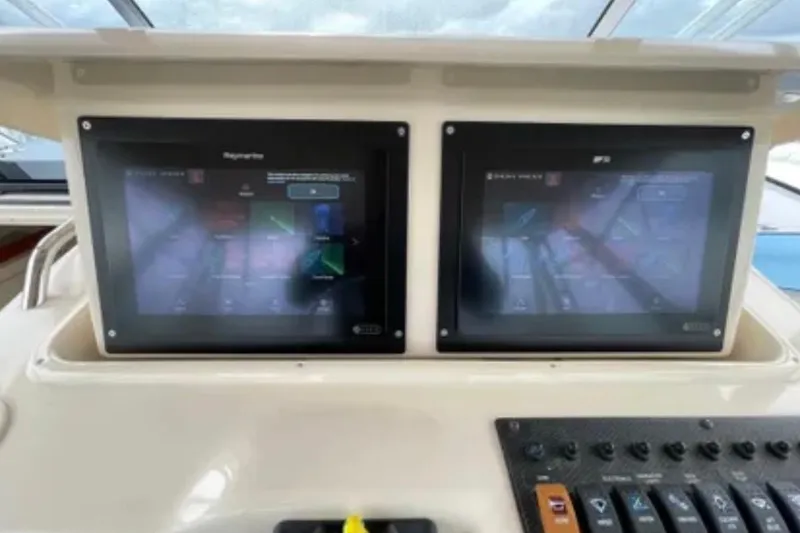 Slide: The Image of Dual navigation screens on a 2007 Grady-White Express 330 boat dashboard. - 23