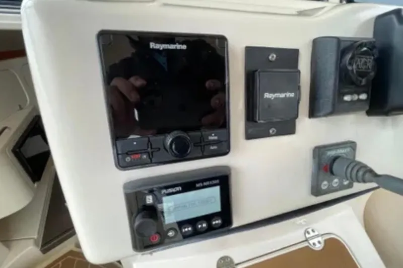 Slide: The Image of Control panel of a 2007 Grady-White Express 330 boat with Raymarine electronics. - 26