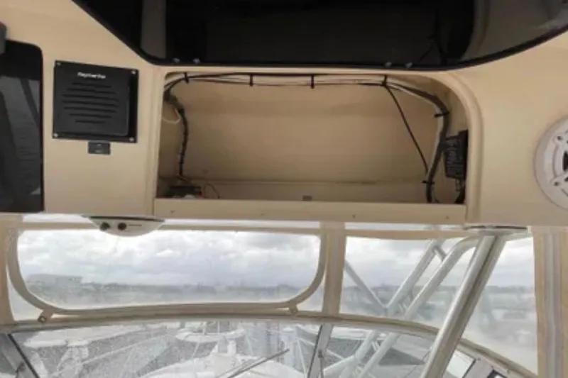 Slide: The Image of 2007 Grady-White Express 330 boat interior with open storage compartment and electronics. - 27