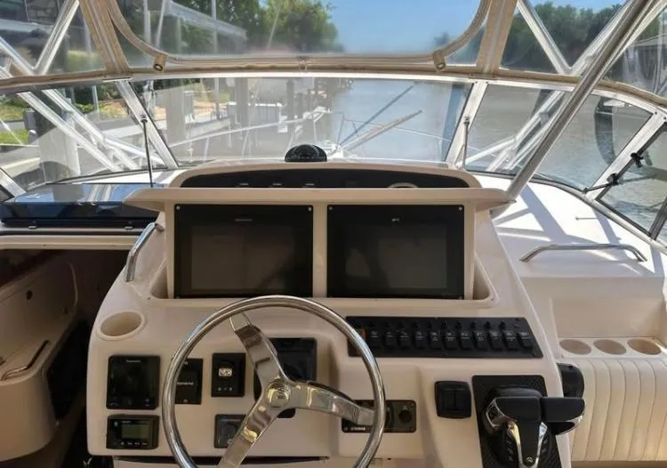 Slide: The Image of 2007 Grady-White Express 330 helm with dual screens and steering wheel. - 3