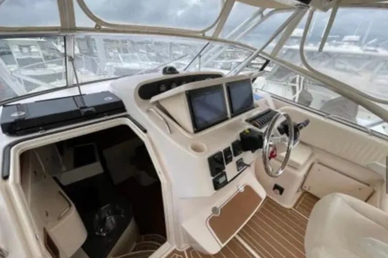 Slide: The Image of 2007 Grady-White Express 330 boat interior with helm, dual screens, and seating. - 31