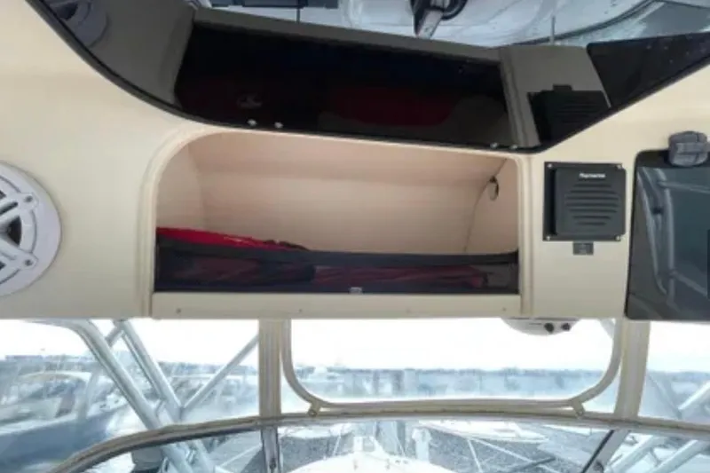 Slide: The Image of 2007 Grady-White Express 330 boat interior storage compartment with speaker and electronics. - 32