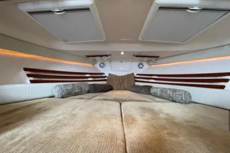 Slide: The Image of 2007 Grady-White Express 330 cabin interior with cozy bedding and ambient lighting. - 38