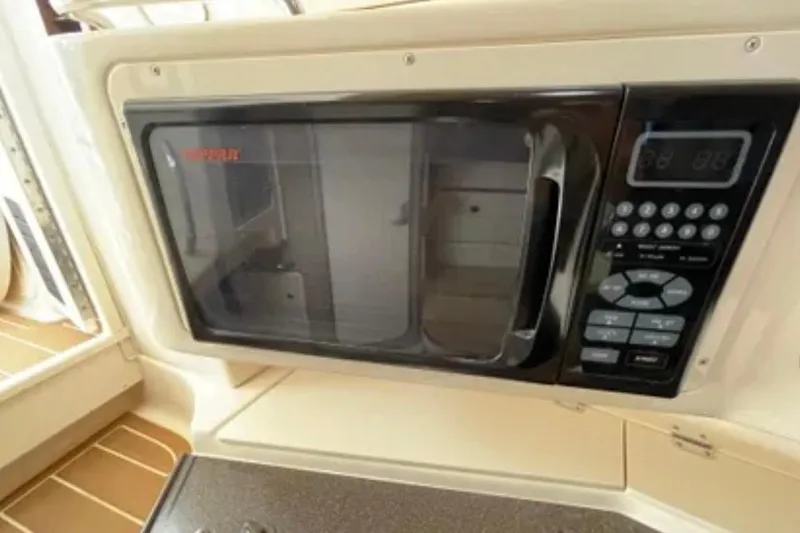 Slide: The Image of Built-in microwave on 2007 Grady-White Express 330 boat, featuring control panel and handle. - 40