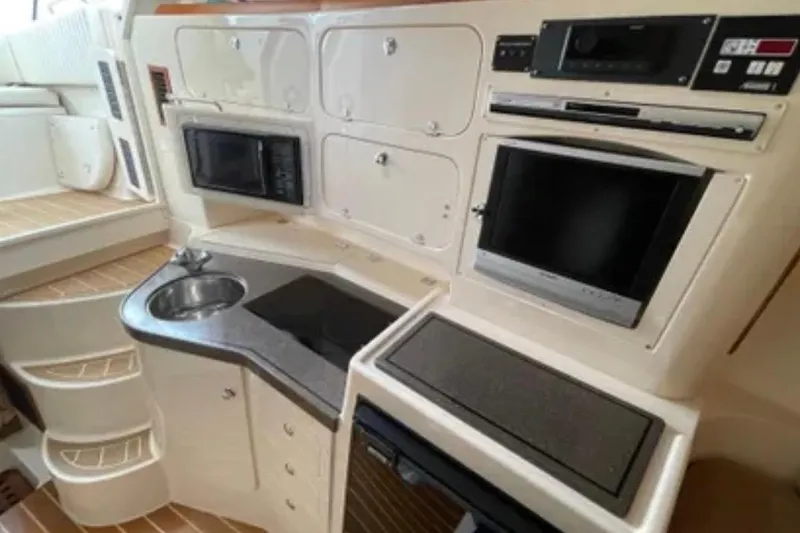 Slide: The Image of 2007 Grady-White Express 330 boat interior with kitchenette, sink, and appliances. - 41