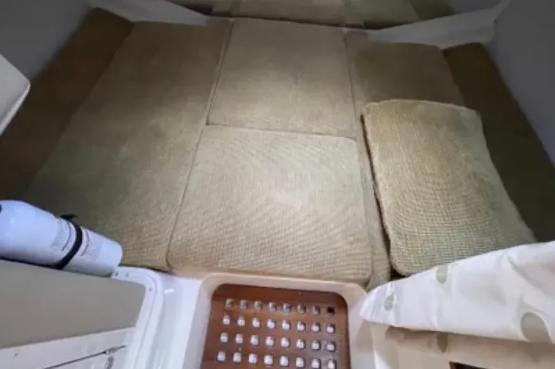 Slide: The Image of 2007 Grady-White Express 330 cabin interior with beige cushions and wooden flooring. - 45