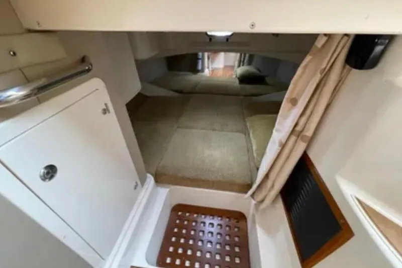 Slide: The Image of 2007 Grady-White Express 330 cabin interior with cozy sleeping area and storage. - 46