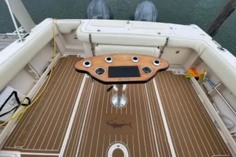 Slide: The Image of 2007 Grady-White Express 330 boat deck with fishing rod holders and cushioned seating. - 49