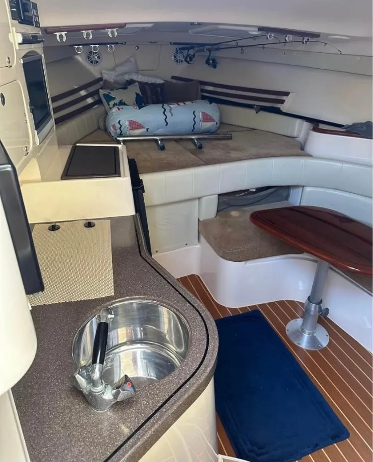 Slide: The Image of Interior of 2007 Grady-White Express 330 boat with kitchenette and seating area. - 5