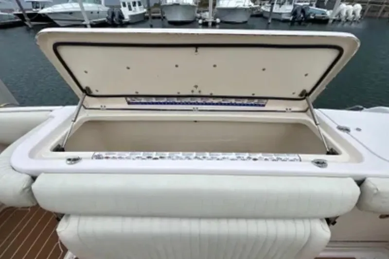 Slide: The Image of Open storage compartment on a 2007 Grady-White Express 330 boat at a marina. - 55
