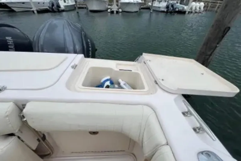 Slide: The Image of 2007 Grady-White Express 330 boat with open storage compartment at marina. - 56