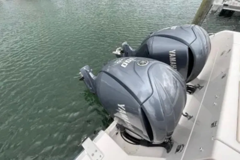 Slide: The Image of Twin Yamaha outboard engines on a 2007 Grady-White Express 330 boat, docked on water. - 57