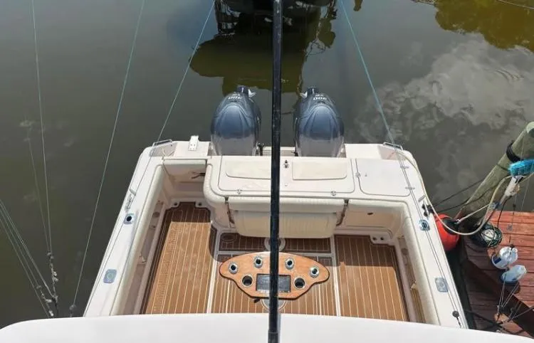 Slide: The Image of 2007 Grady-White Express 330 boat with twin engines, docked on calm water. - 8