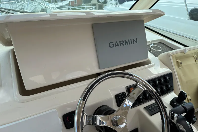 Slide: The Image of 2021 Grady-White Express 330 helm with Garmin navigation system and steering wheel. - 11