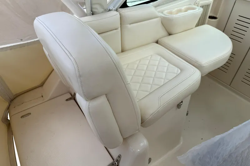 Slide: The Image of Luxurious seating on 2021 Grady-White Express 330 boat, featuring white leather upholstery. - 13