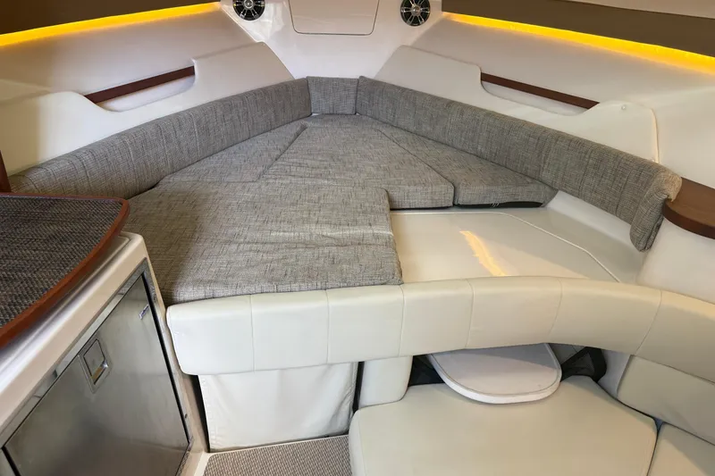 Slide: The Image of 2021 Grady-White Express 330 cabin interior with cushioned seating and modern design. - 14