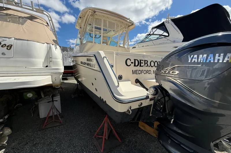 Slide: The Image of 2021 Grady-White Express 330 boat with Yamaha engine, docked outdoors under blue sky. - 15
