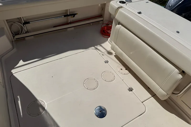 Slide: The Image of 2021 Grady-White Express 330 boat deck with seating and storage compartments. - 17