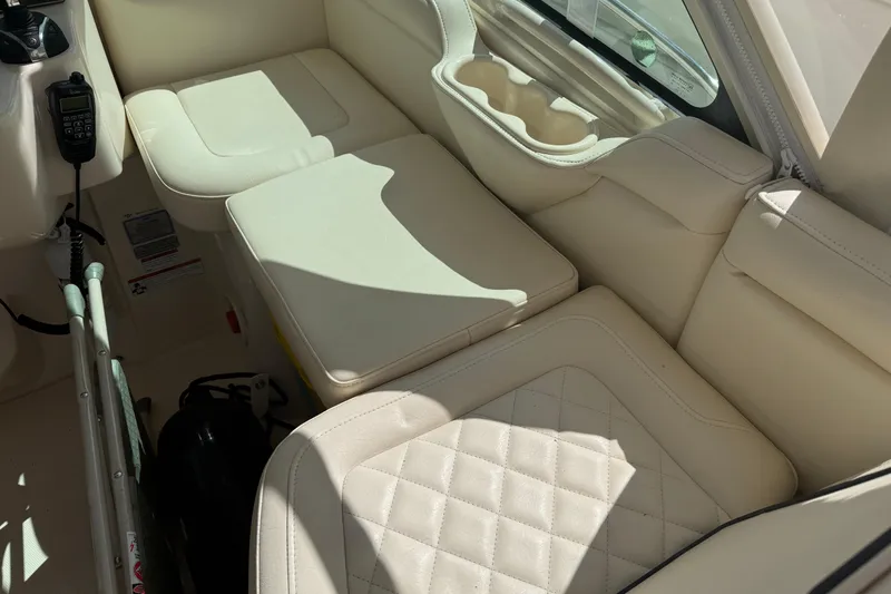 Slide: The Image of Luxurious interior seating of 2021 Grady-White Express 330 boat with beige upholstery. - 18