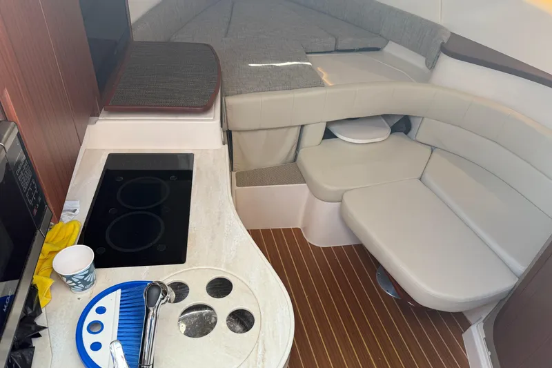 Slide: The Image of 2021 Grady-White Express 330 cabin interior with kitchenette and seating area. - 19