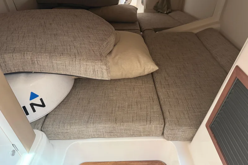 Slide: The Image of Interior cabin of 2021 Grady-White Express 330 with cushioned seating and storage. - 22