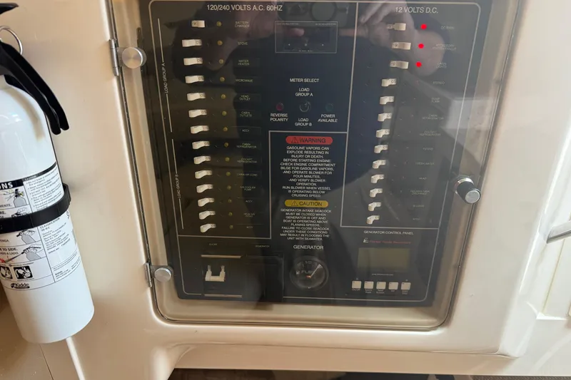 Slide: The Image of Electrical control panel on a 2021 Grady-White Express 330 boat with fire extinguisher. - 24