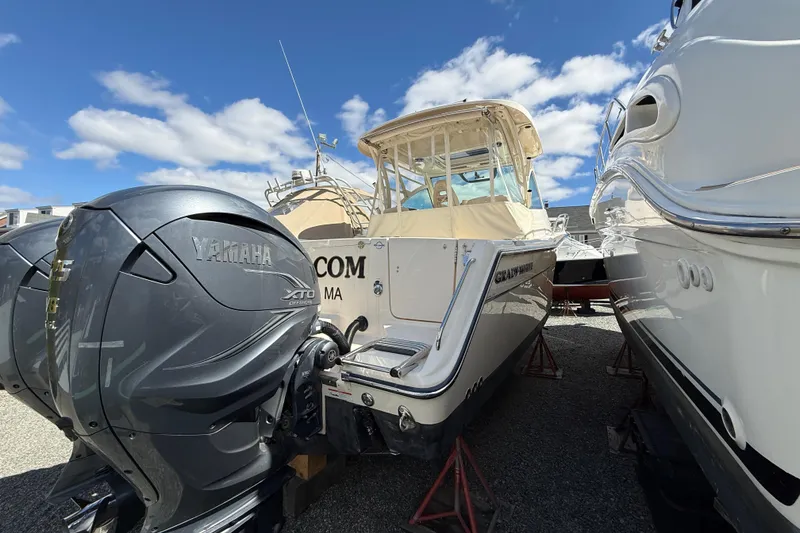 Slide: The Image of 2021 Grady-White Express 330 boat with Yamaha XTO engines, docked under a clear blue sky. - 3