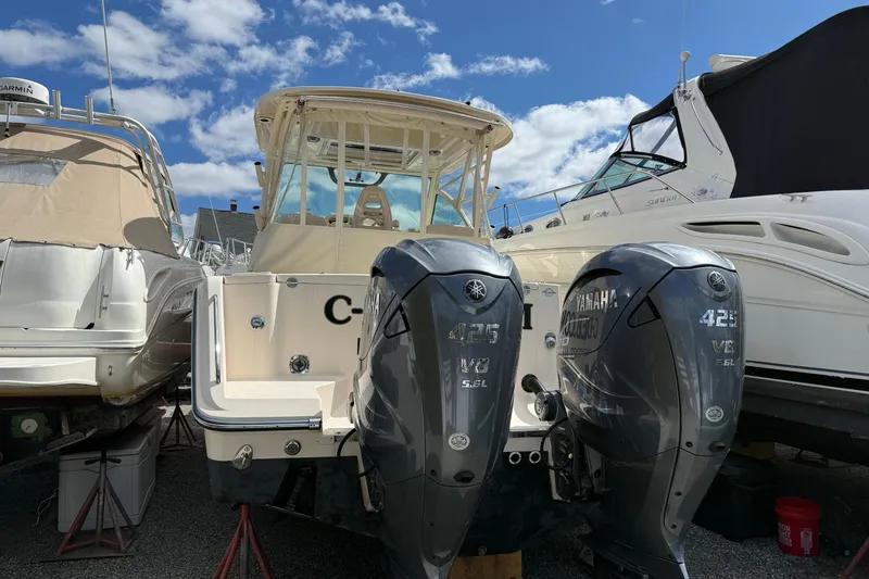 Slide: The Image of 2021 Grady-White Express 330 boat with twin Yamaha 425 V8 engines, docked under a blue sky. - 4