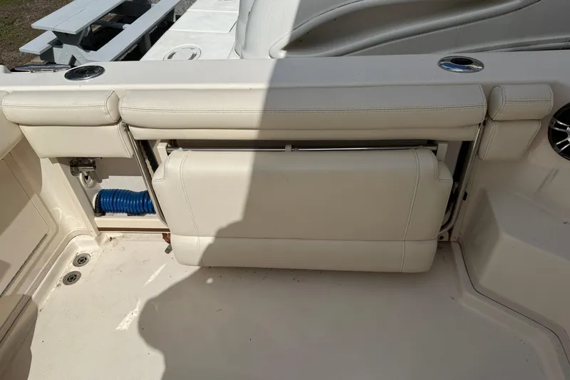 Slide: The Image of 2021 Grady-White Express 330 boat interior with foldable seat and storage compartment. - 6