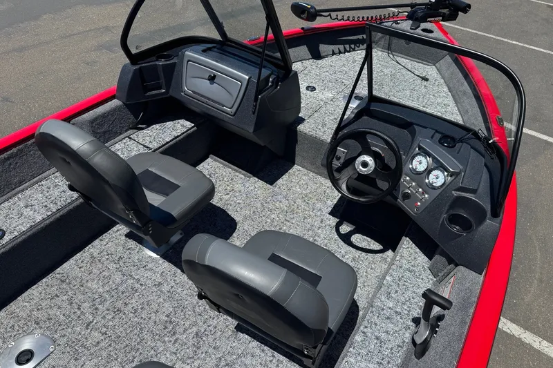 Slide: The Image of 2026 Tracker Pro Guide V-16 WT boat interior with steering console and seating. - 11