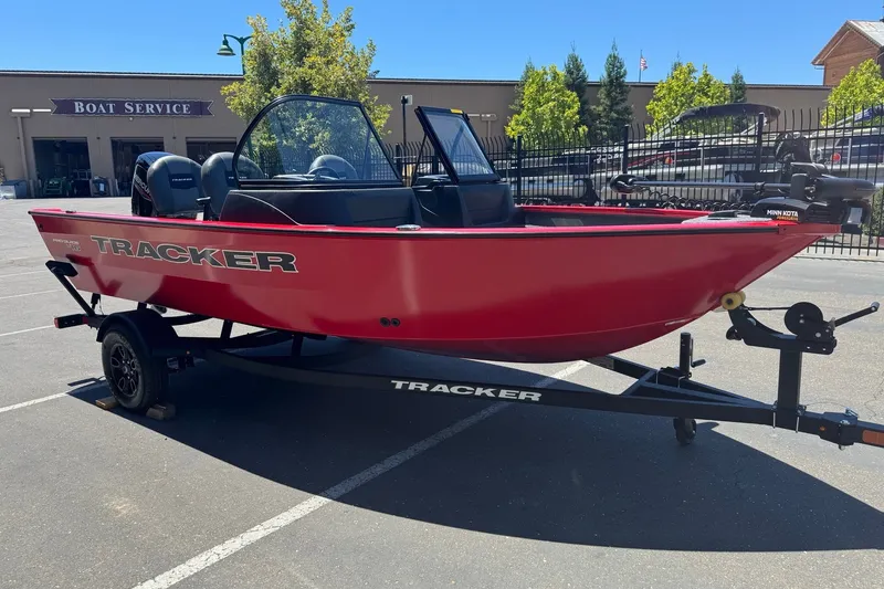 Slide: The Image of 2026 Tracker Pro Guide V-16 WT boat on trailer in parking lot. - 6
