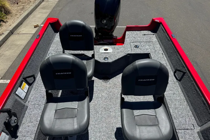 Slide: The Image of 2026 Tracker Pro Guide V-16 WT boat interior with two seats and motor. - 9