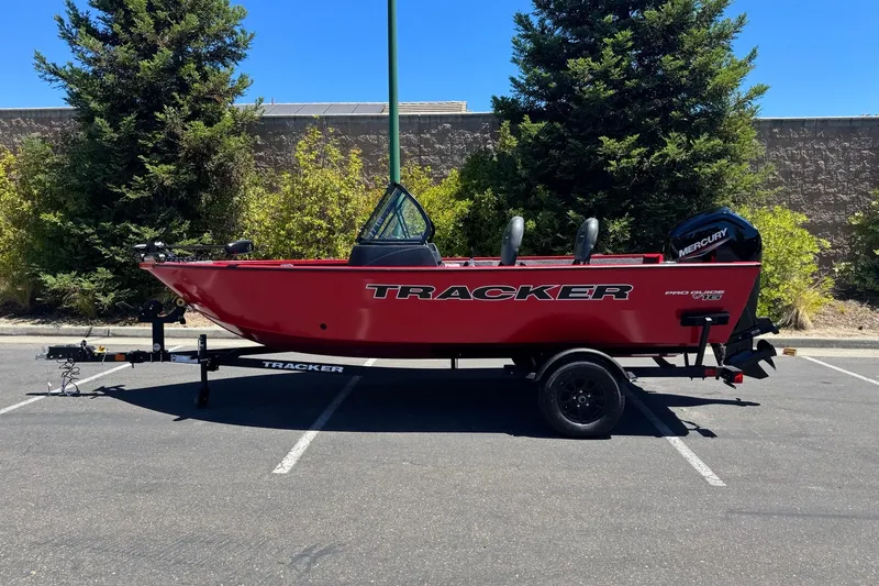 The Image of 2026 Tracker Pro Guide V-16 WT boat on trailer, parked outdoors. - 0