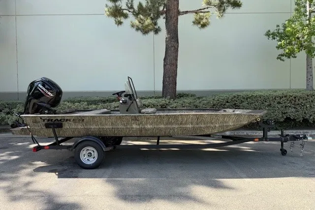 The Image of 2026 Tracker Grizzly 1860 CC boat on trailer, parked outdoors. - 0