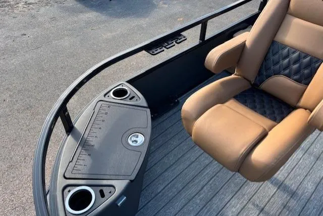Slide: The Image of 2026 Ranger 220F boat interior with tan seating and integrated cup holders. - 10