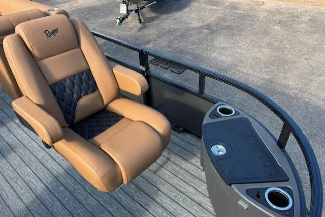 Slide: The Image of Luxurious seating on 2026 Ranger 220F boat with tan upholstery and cup holders. - 11