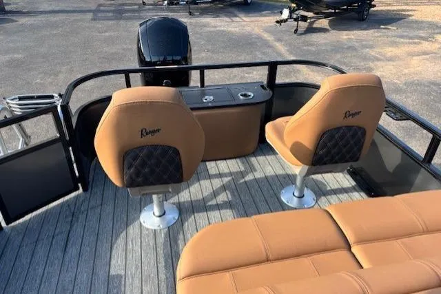 Slide: The Image of 2026 Ranger 220F boat interior with tan seats and modern design. - 13