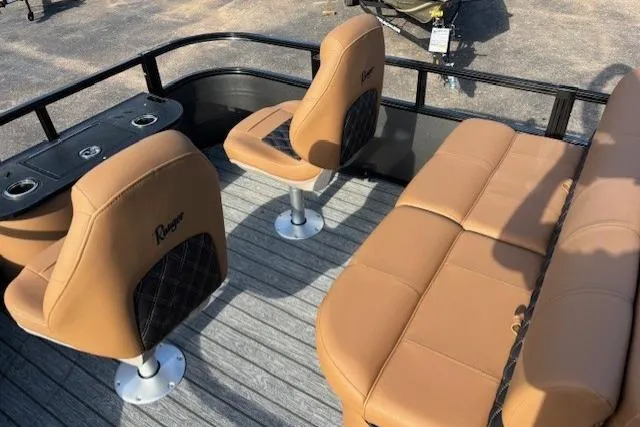 Slide: The Image of 2026 Ranger 220F boat interior with tan seating and cup holders on deck. - 14
