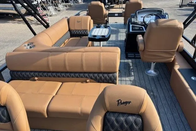Slide: The Image of 2026 Ranger 220F boat interior with tan leather seating and modern dashboard. - 17