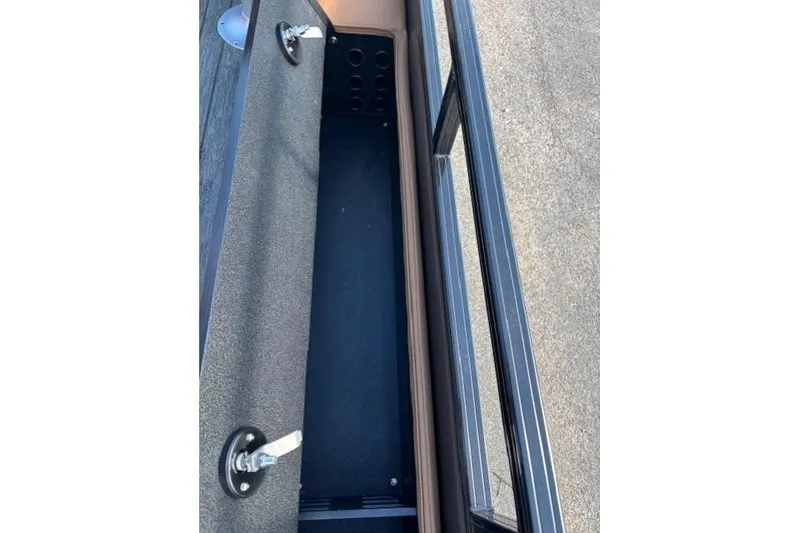 Slide: The Image of Storage compartment of 2026 Ranger 220F boat, featuring secure latch and spacious interior. - 18