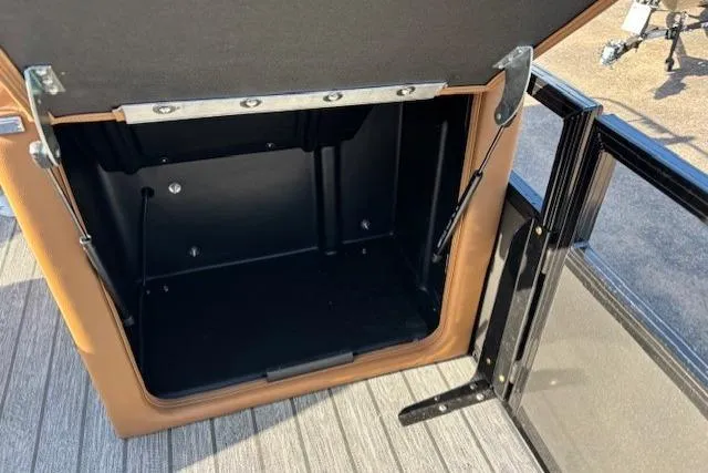 Slide: The Image of Open storage compartment in 2026 Ranger 220F boat, featuring durable construction and sleek design. - 24