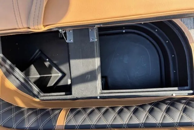 Slide: The Image of Storage compartment in 2026 Ranger 220F boat with tan and black quilted upholstery. - 25