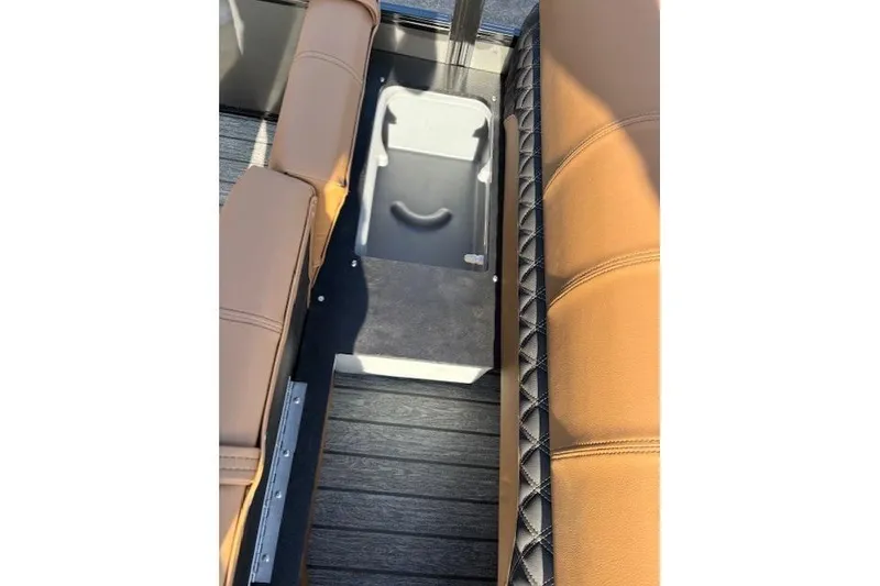 Slide: The Image of 2026 Ranger 220F boat interior with tan seating and storage compartment. - 26