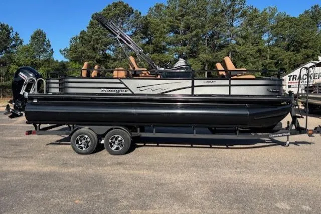 Slide: The Image of 2026 Ranger 220F pontoon boat on trailer, parked outdoors with trees in background. - 3
