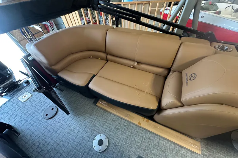 Slide: The Image of Luxurious seating on 2026 Regency 230 DL boat with tan upholstery and cup holder. - 70